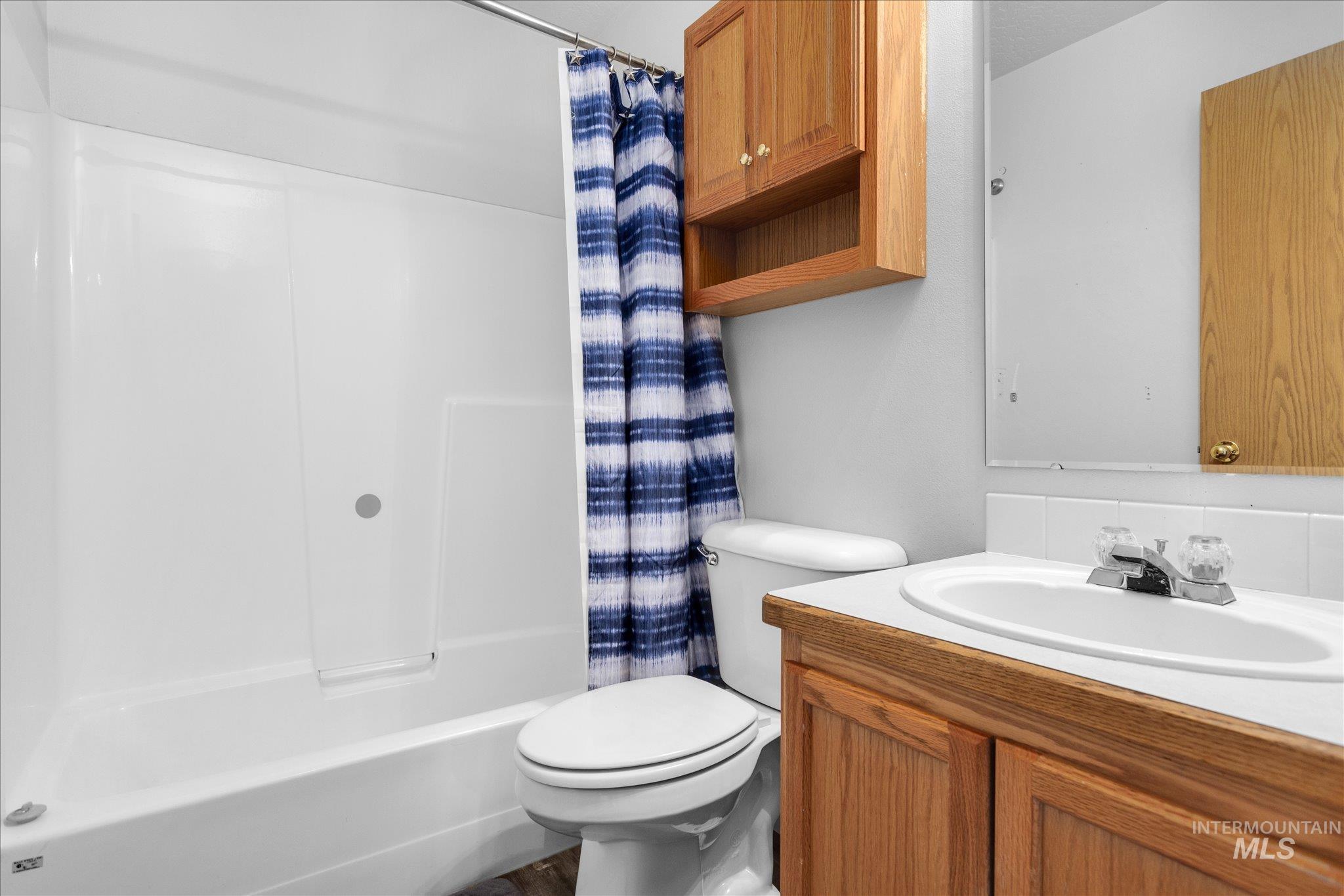 Bathroom with vanity and shower / tub combo with curtain