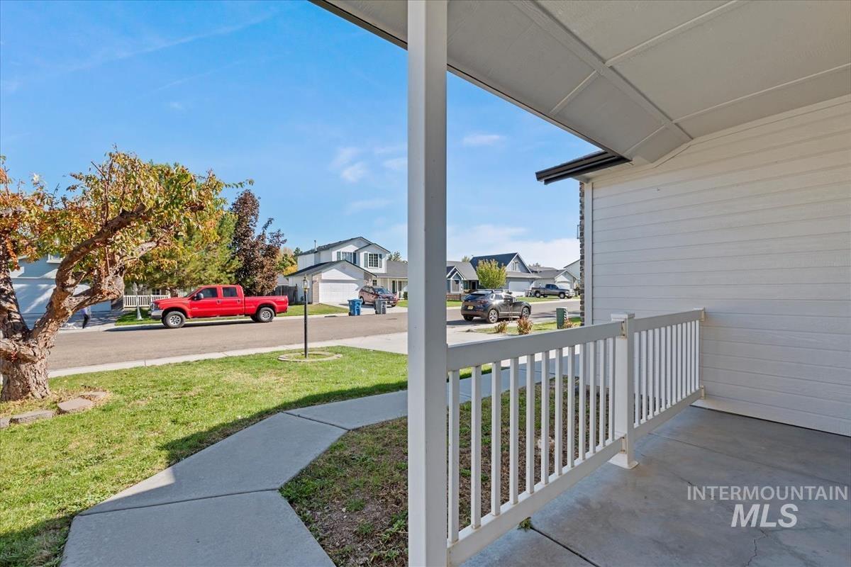 Porch featuring a residential view and a yard