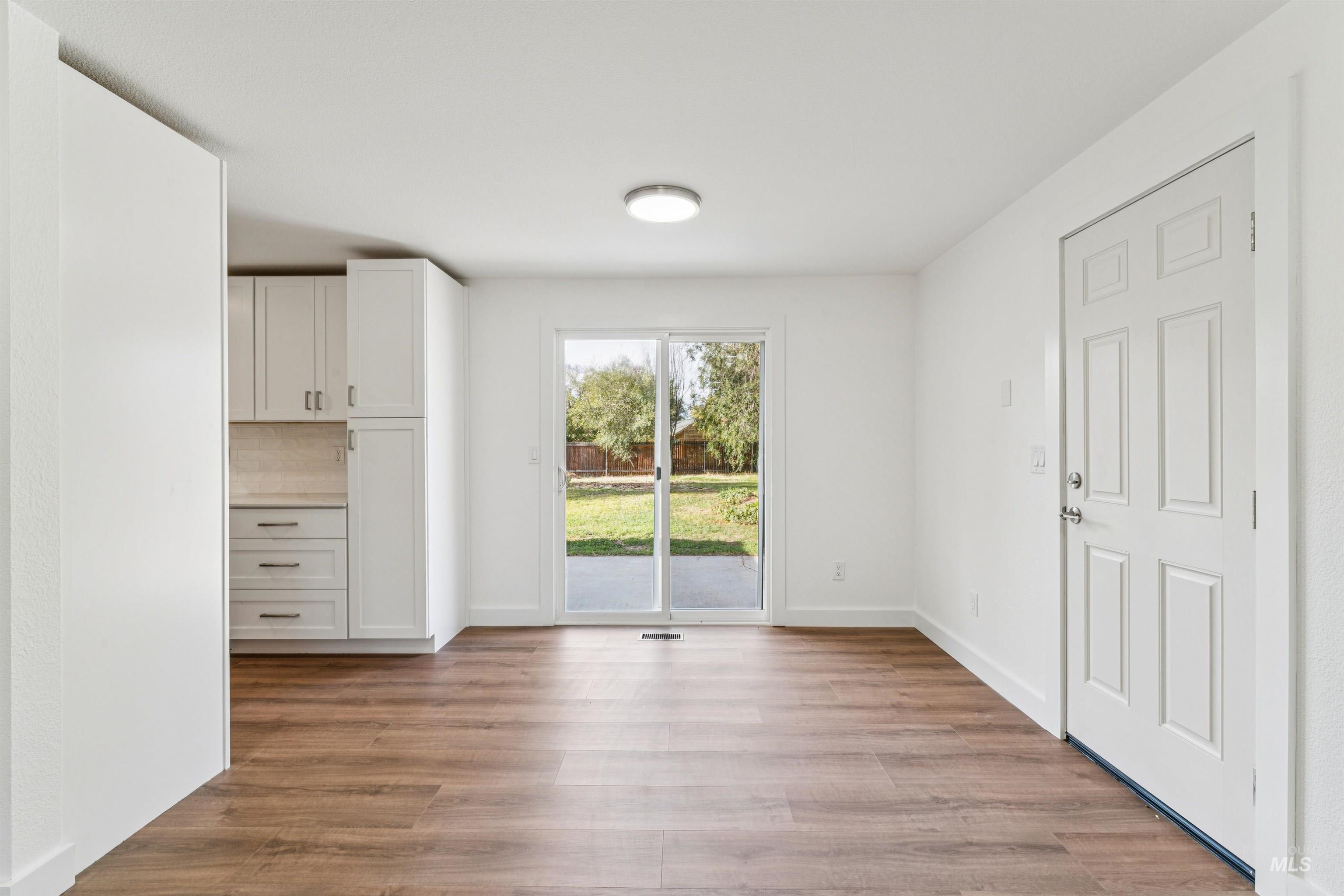 Unfurnished dining area with light wood finished floors