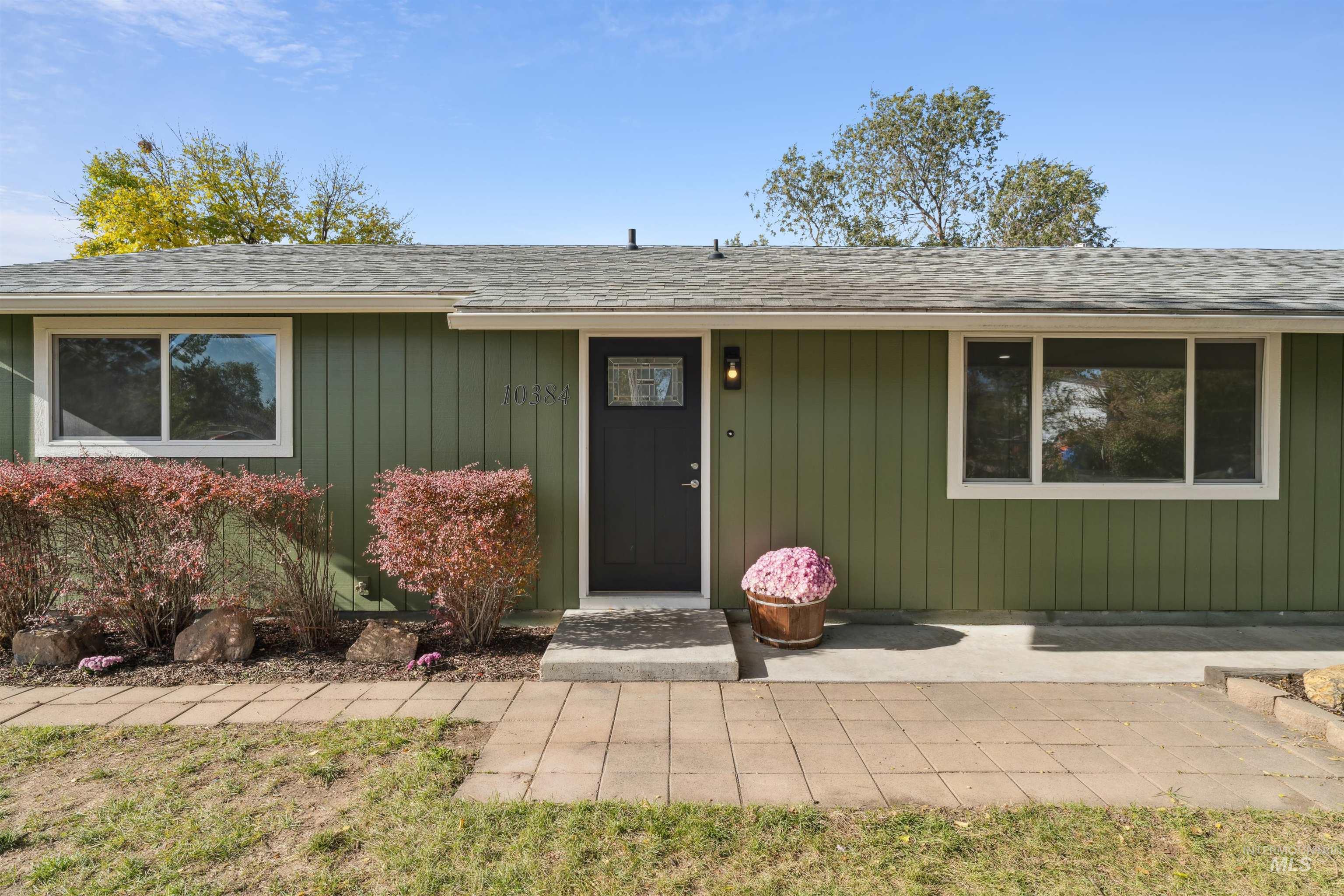 Entrance to property with roof with shingles