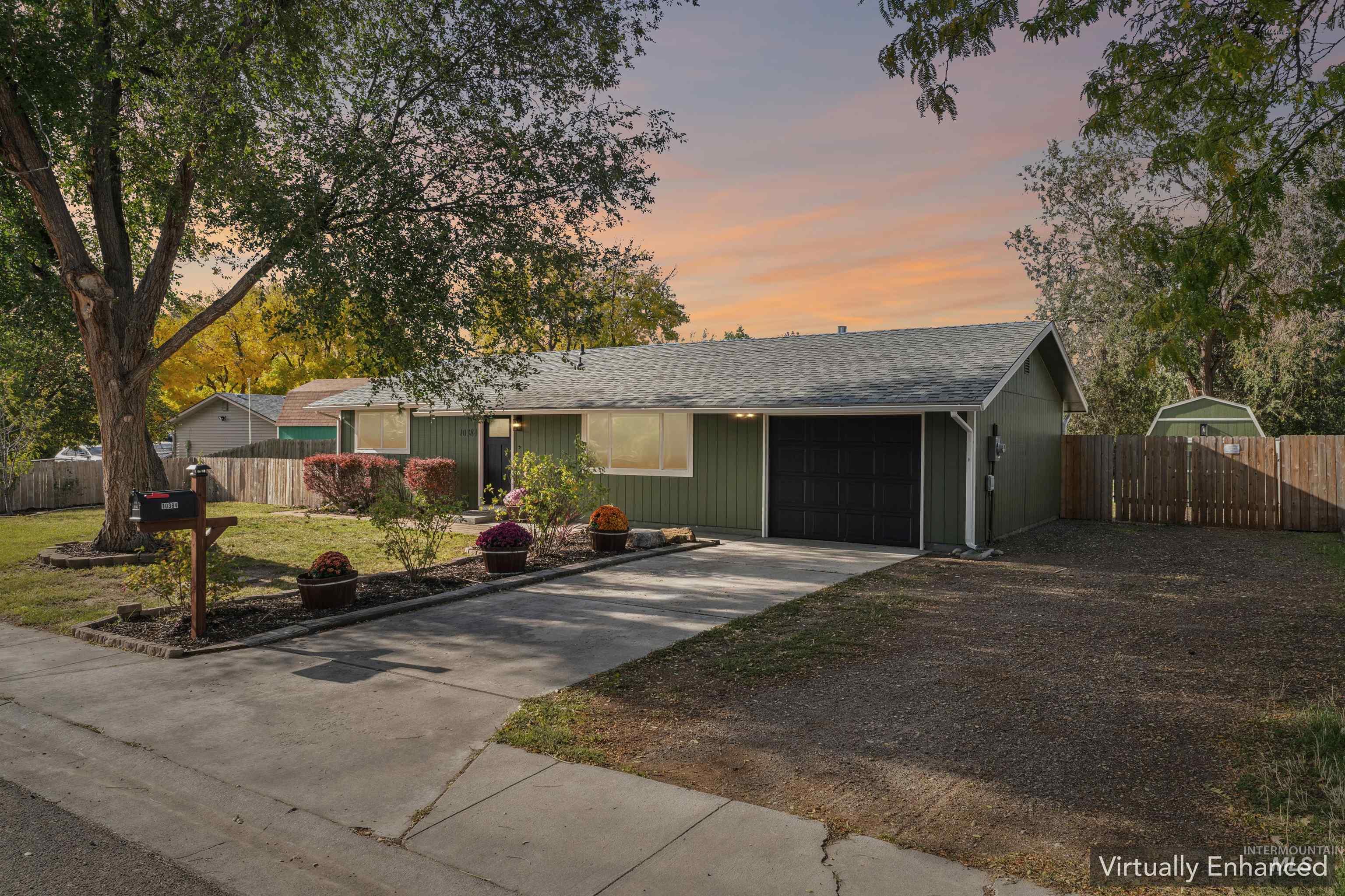 Single story home featuring an attached garage, concrete driveway, and roof with shingles
