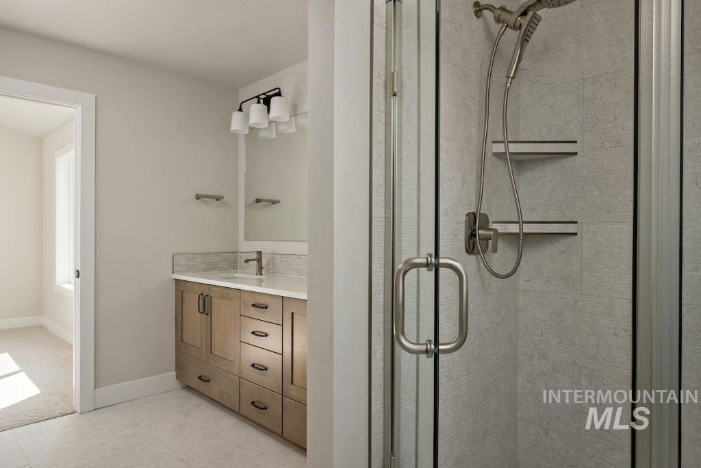 Full bath featuring vanity and a stall shower