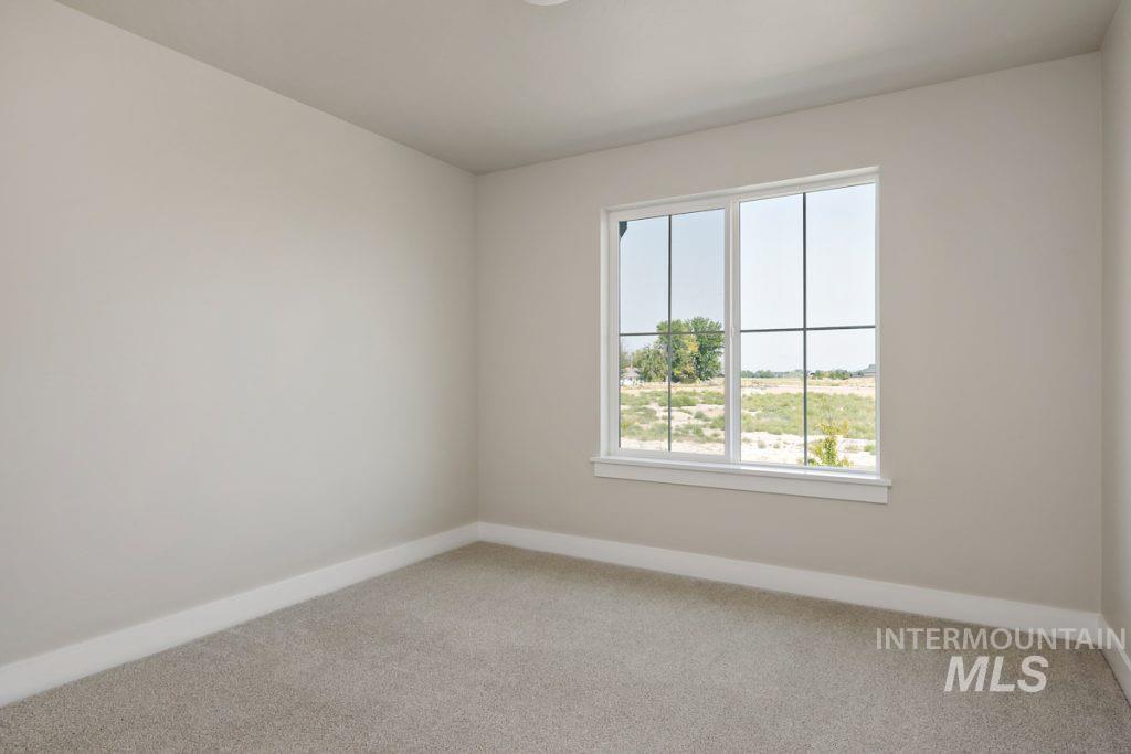 Spare room featuring light colored carpet