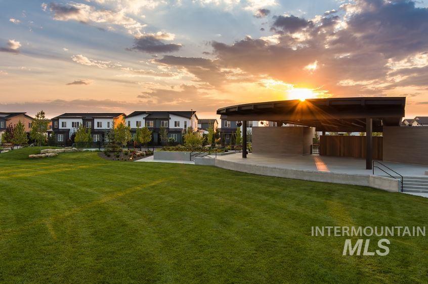 Yard at dusk featuring a lawn and a patio