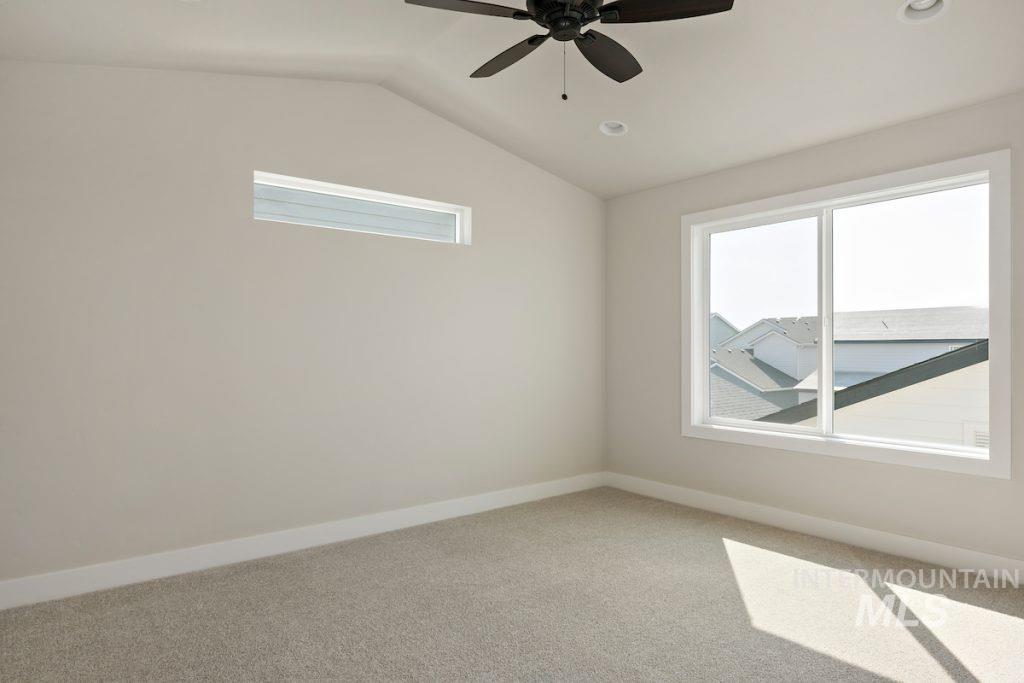 Empty room featuring light carpet, lofted ceiling, a ceiling fan, and recessed lighting