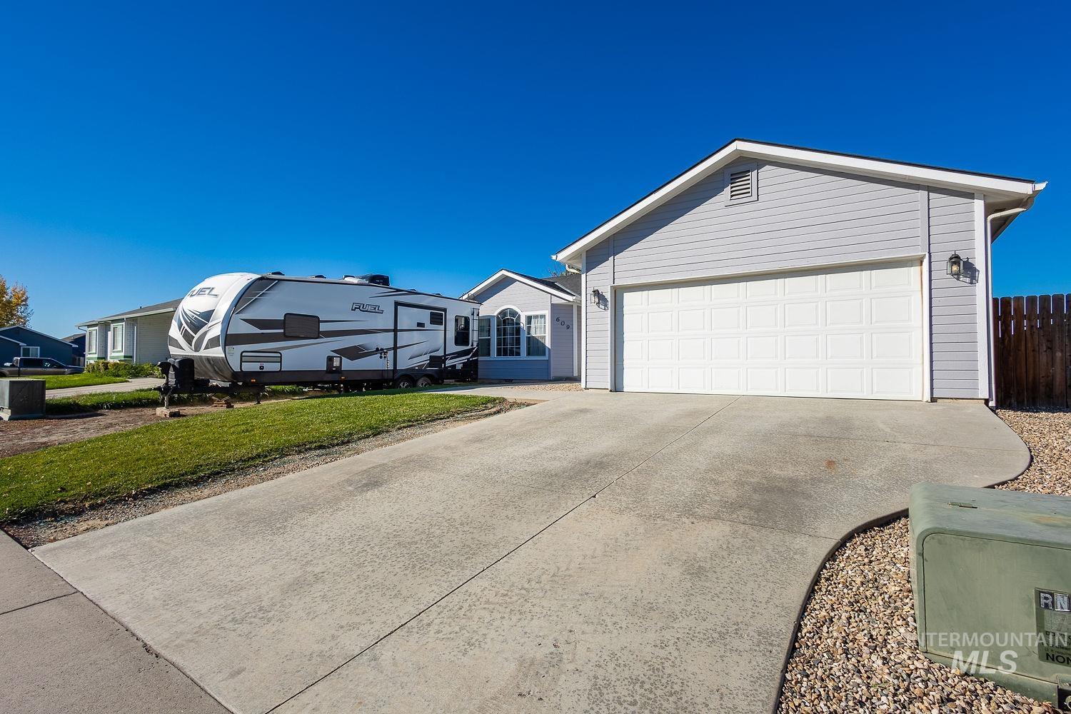 Single story home featuring driveway and a garage