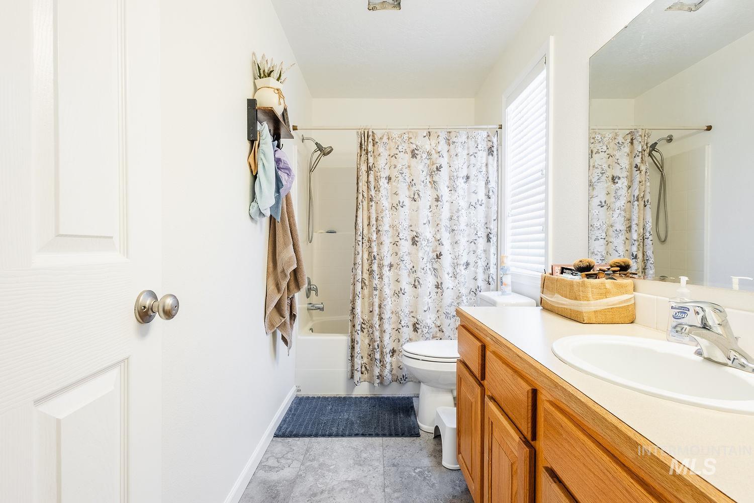 Bathroom featuring shower / bath combo and vanity