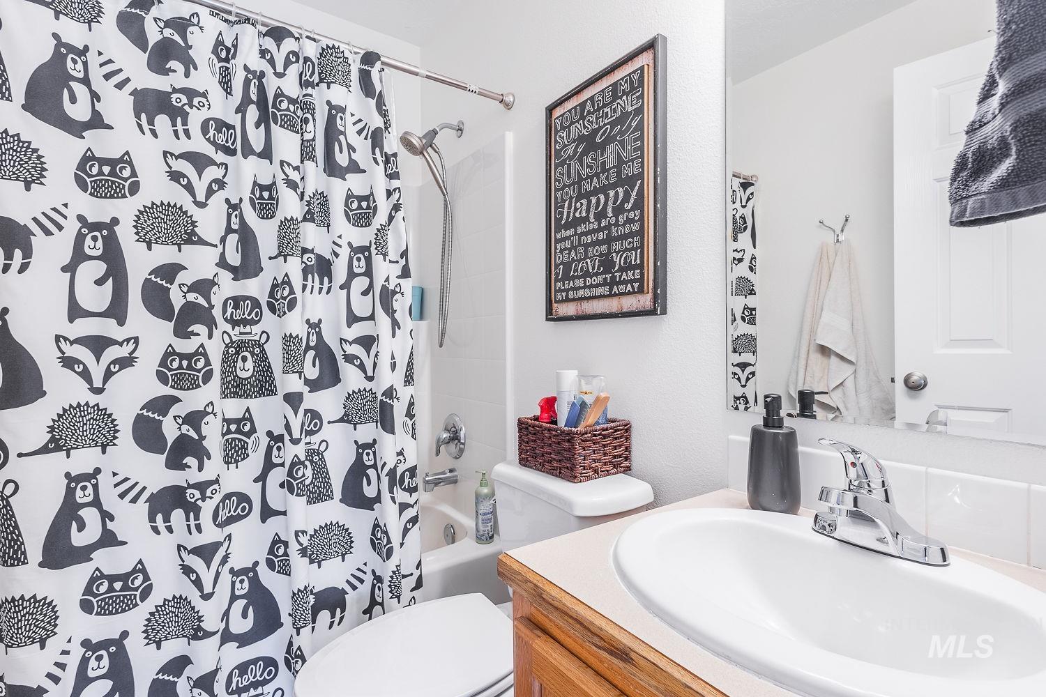 Bathroom with vanity and shower / tub combo with curtain