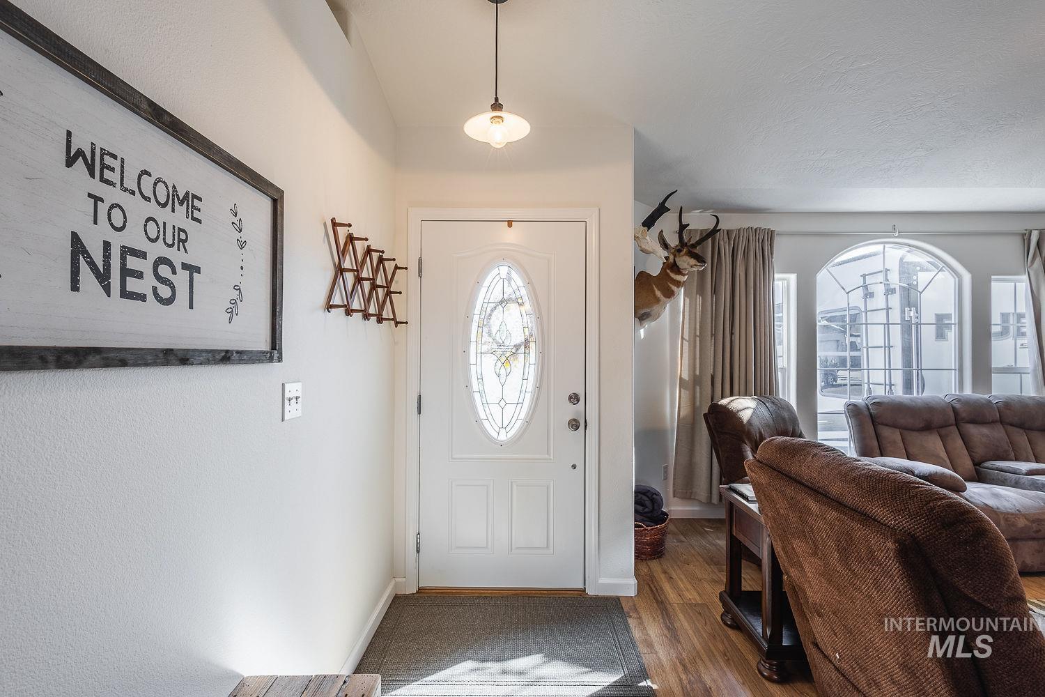 Foyer with wood finished floors and baseboards