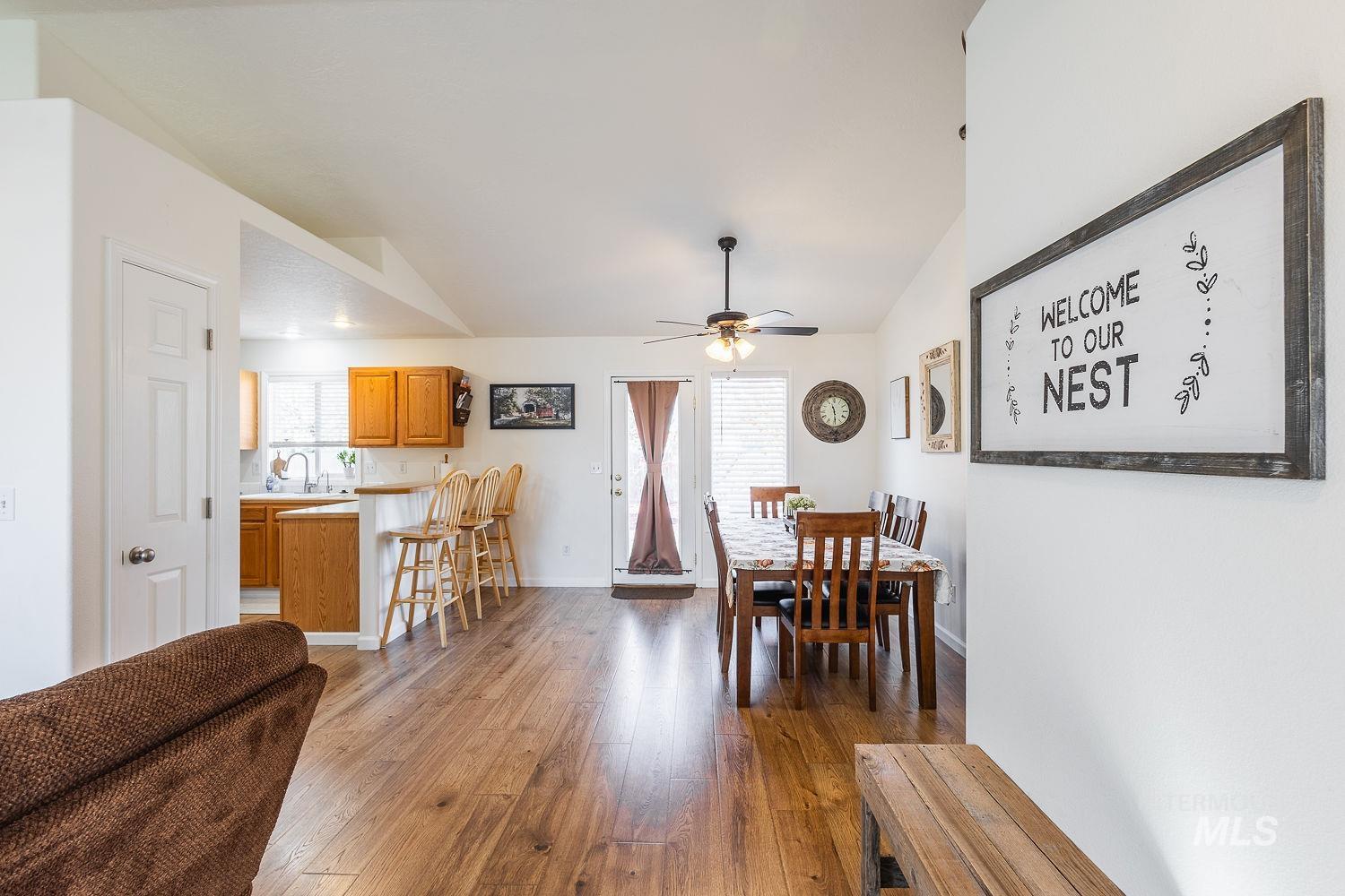 Dining space with dark wood finished floors and a ceiling fan