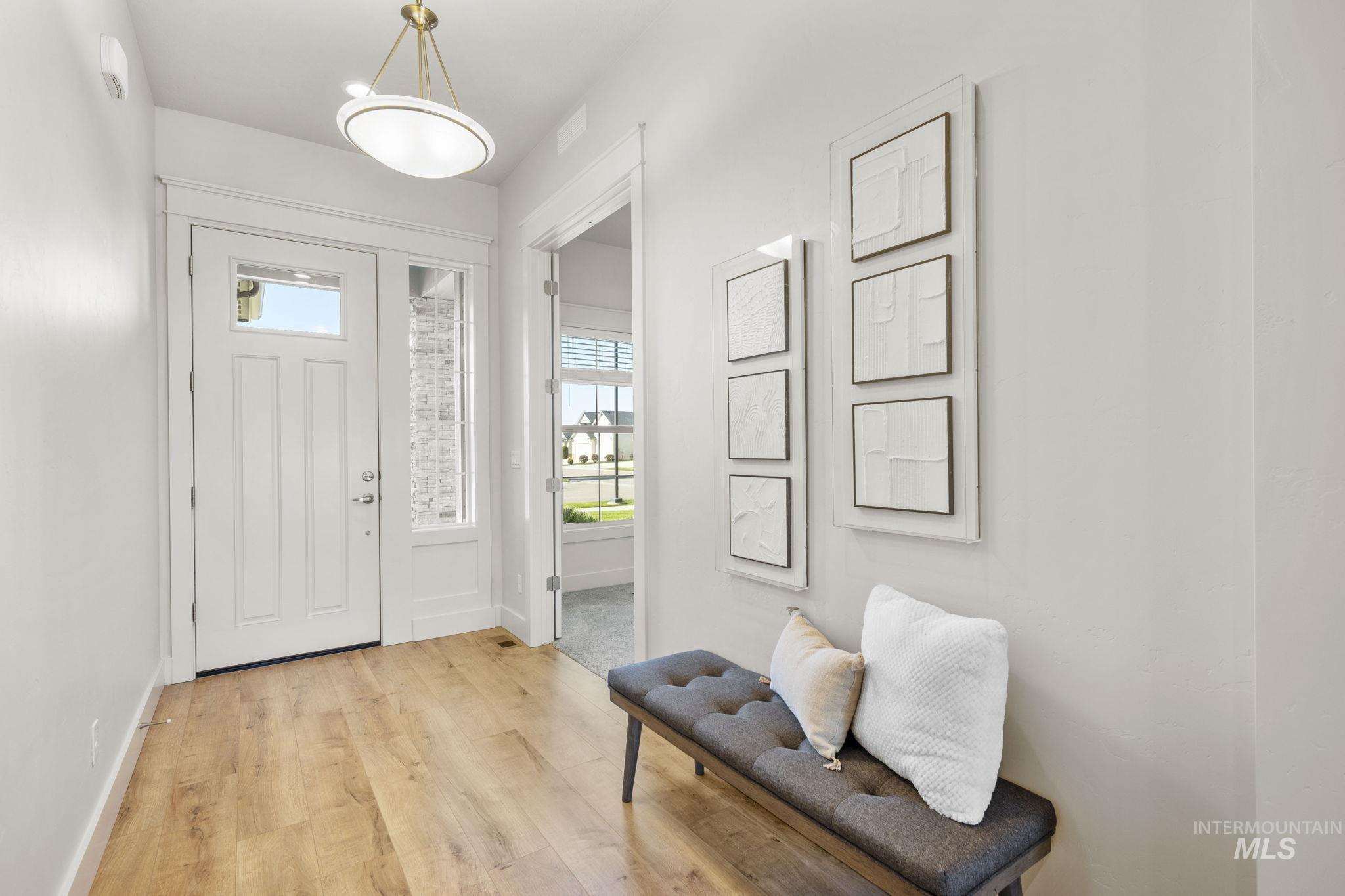 Entryway with plenty of natural light and light wood-style floors