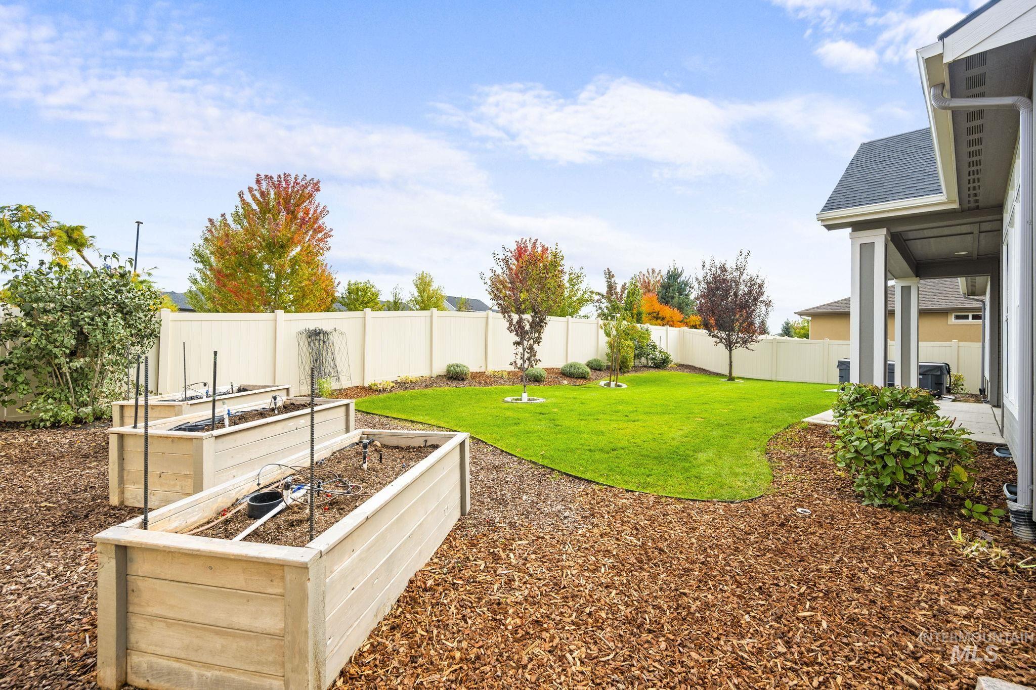 Fenced backyard featuring a patio area and a garden