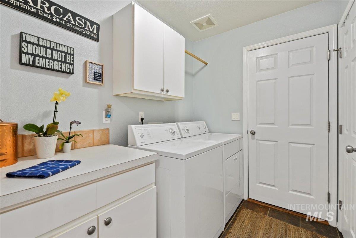 Laundry room featuring included washer and dryer and cabinet space
