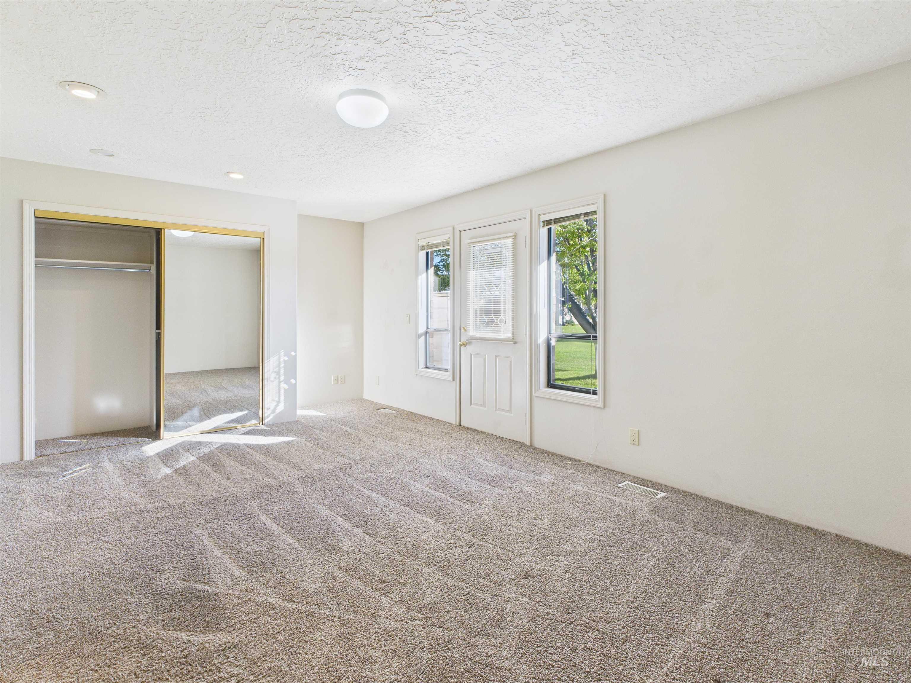 Unfurnished bedroom featuring carpet, a closet, and a textured ceiling