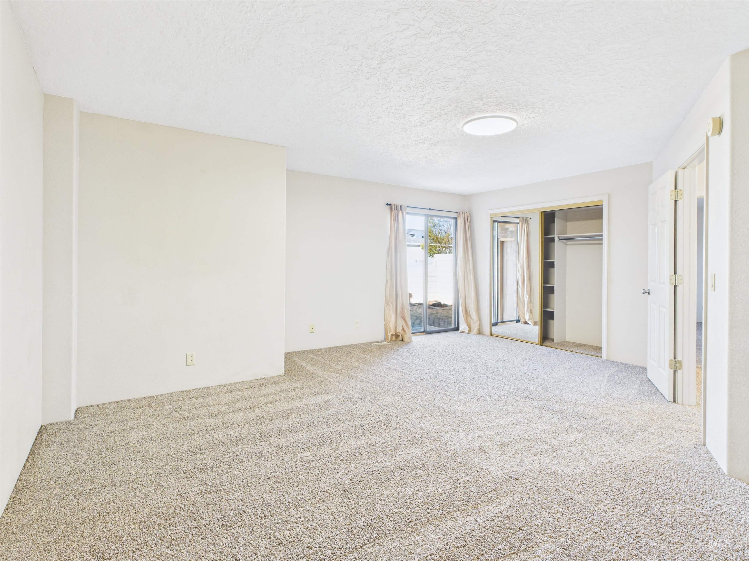 Carpeted spare room featuring a textured ceiling