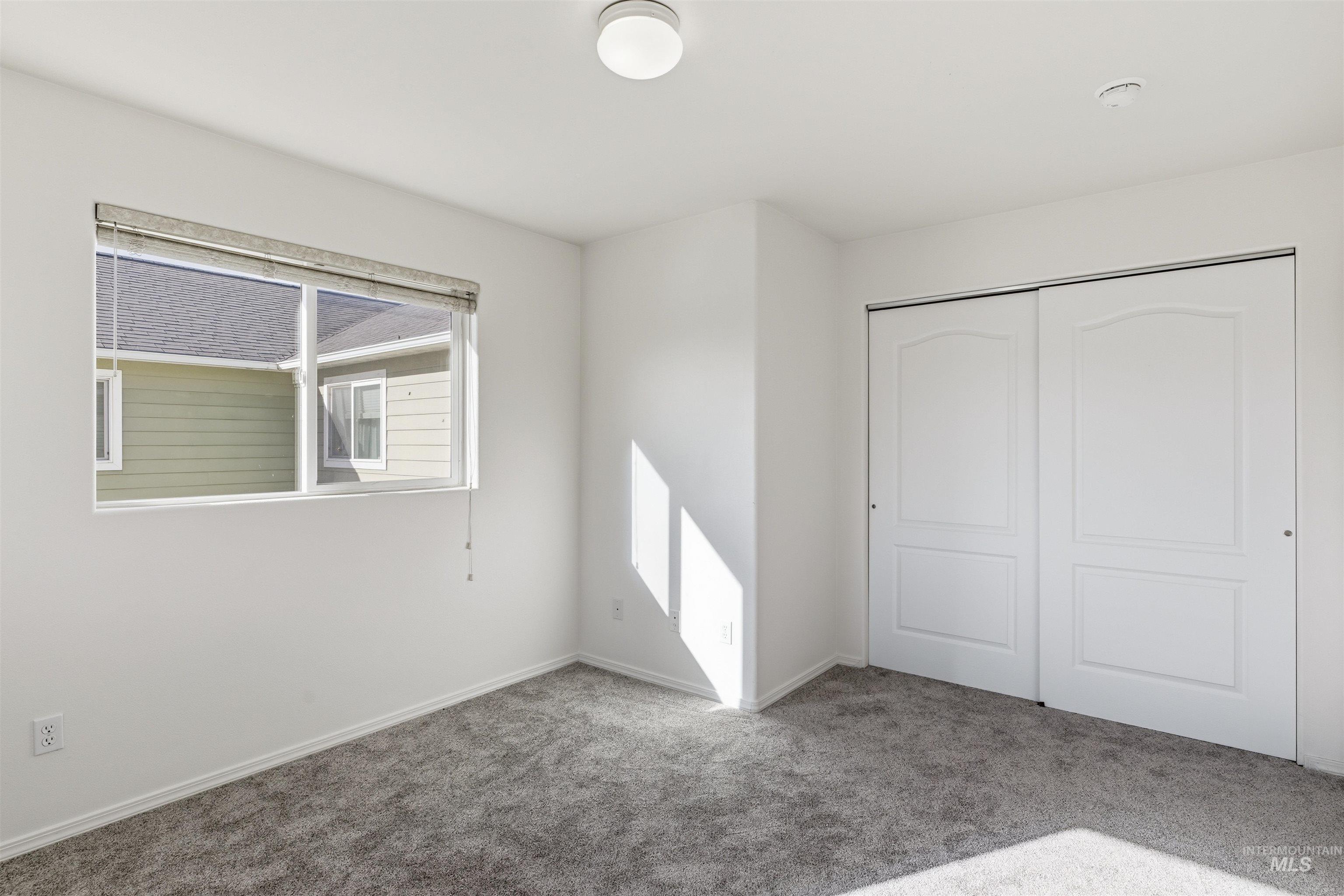 Unfurnished bedroom featuring carpet floors and a closet