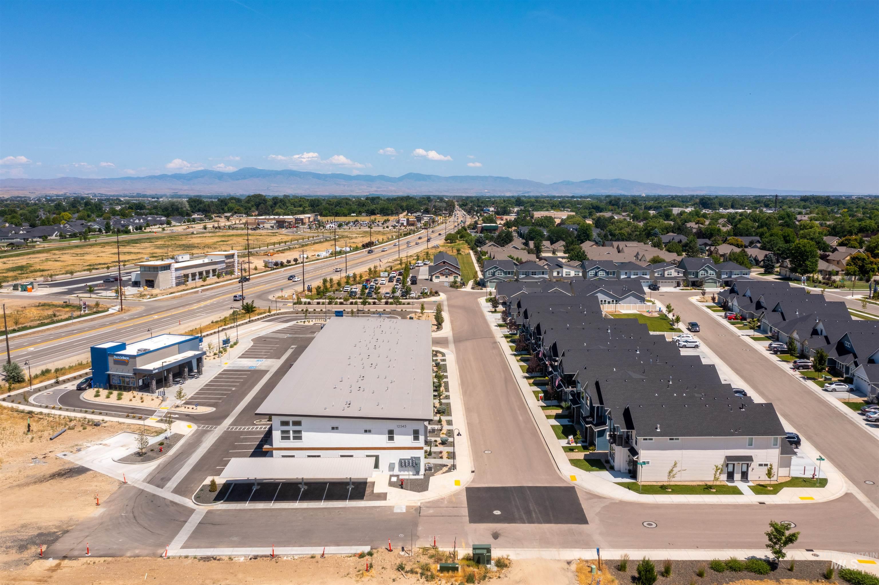 Aerial perspective of suburban area featuring a mountain backdrop
