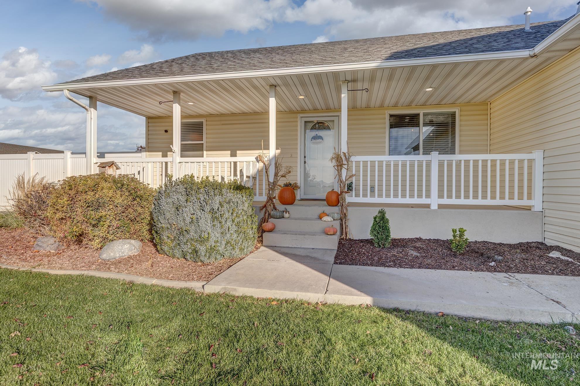 Entrance to property with roof with shingles and a porch