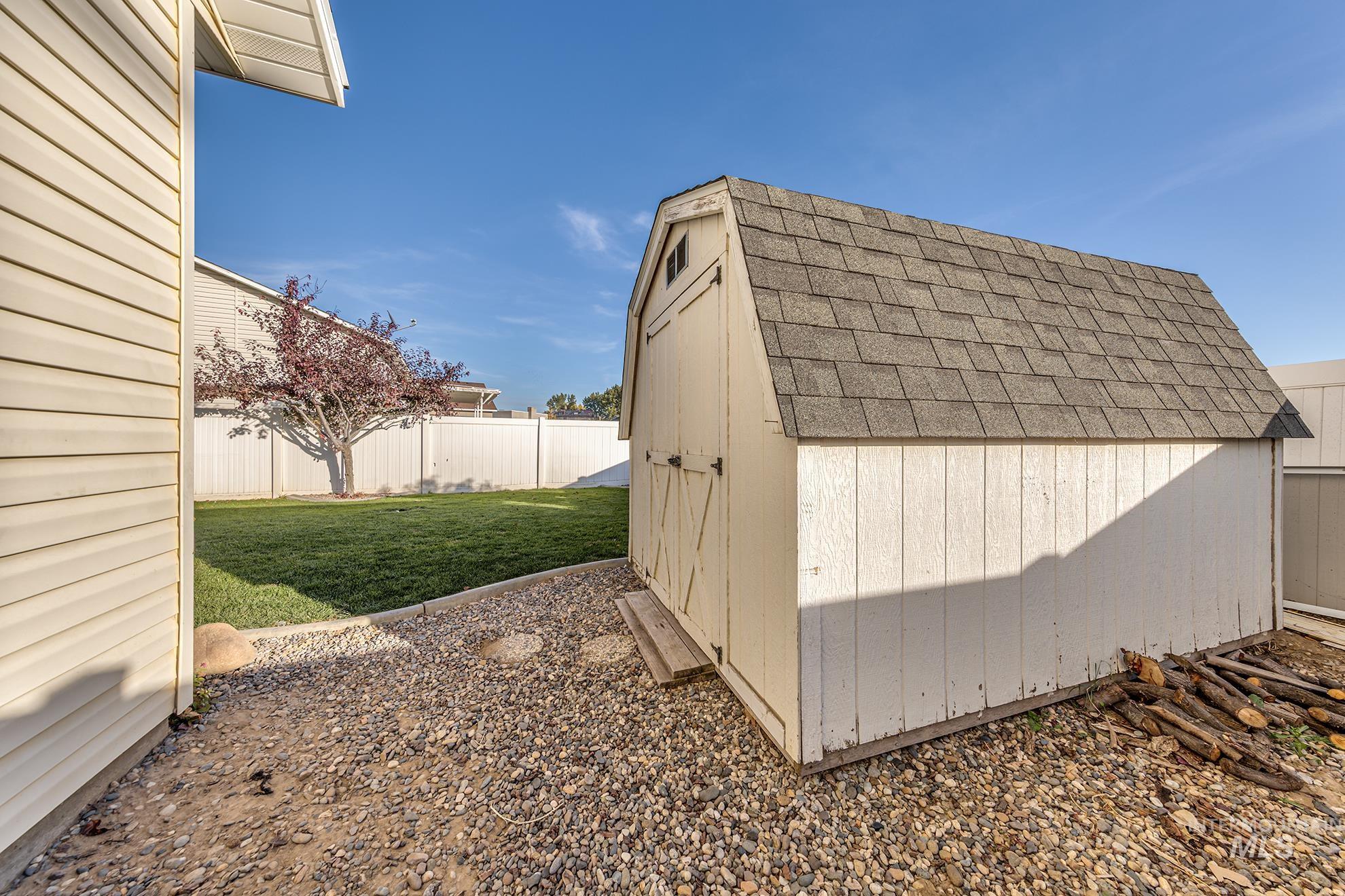 View of shed with a fenced backyard