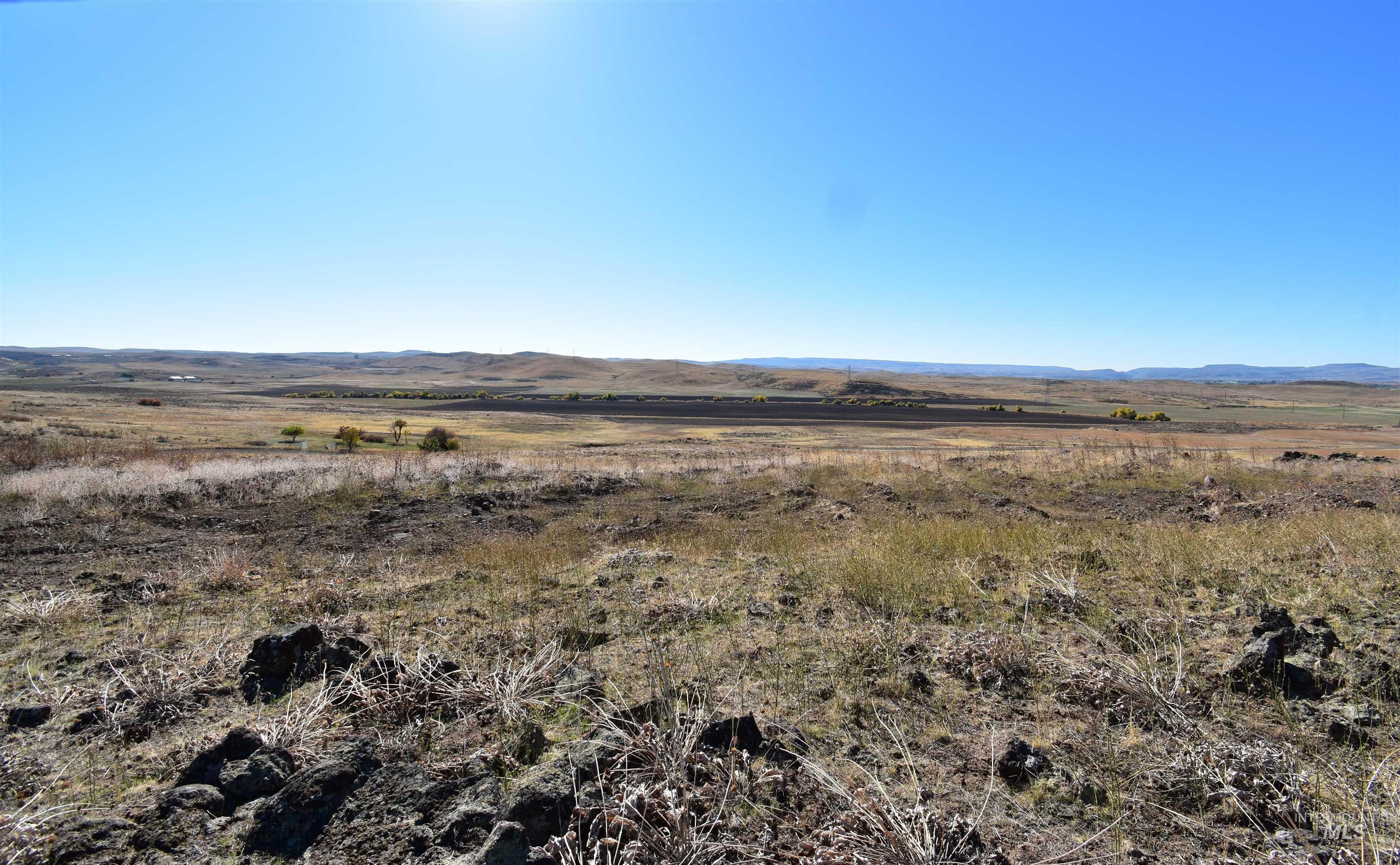 View of mountain backdrop with rural landscape