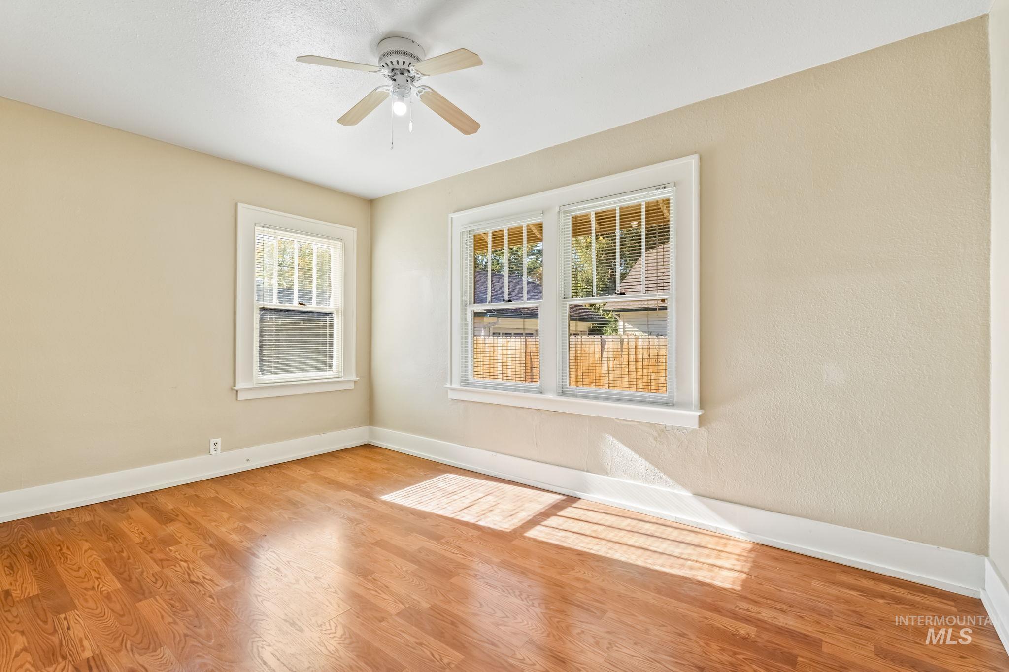 Unfurnished room featuring wood finished floors and a ceiling fan
