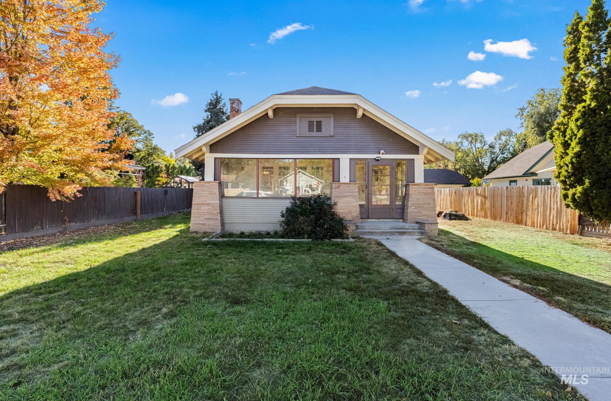 Bungalow with a fenced backyard and a chimney