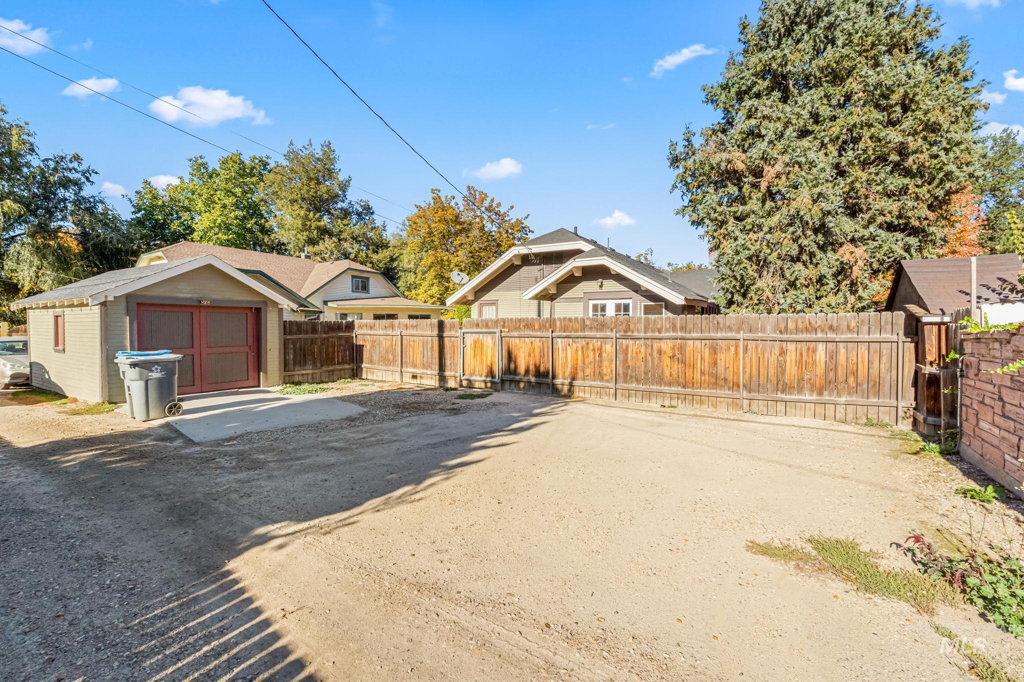 Fenced backyard featuring an outdoor structure