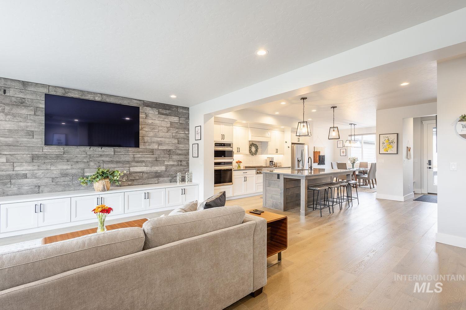 Living area featuring light wood-style flooring and recessed lighting