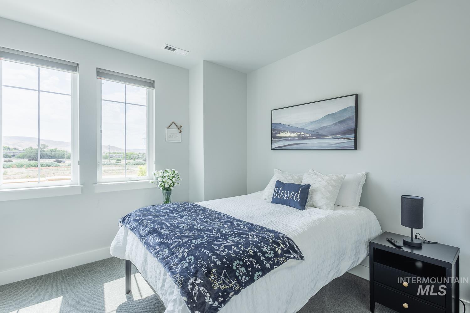 Bedroom featuring carpet flooring and baseboards