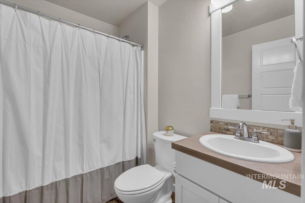 Bathroom featuring vanity and backsplash