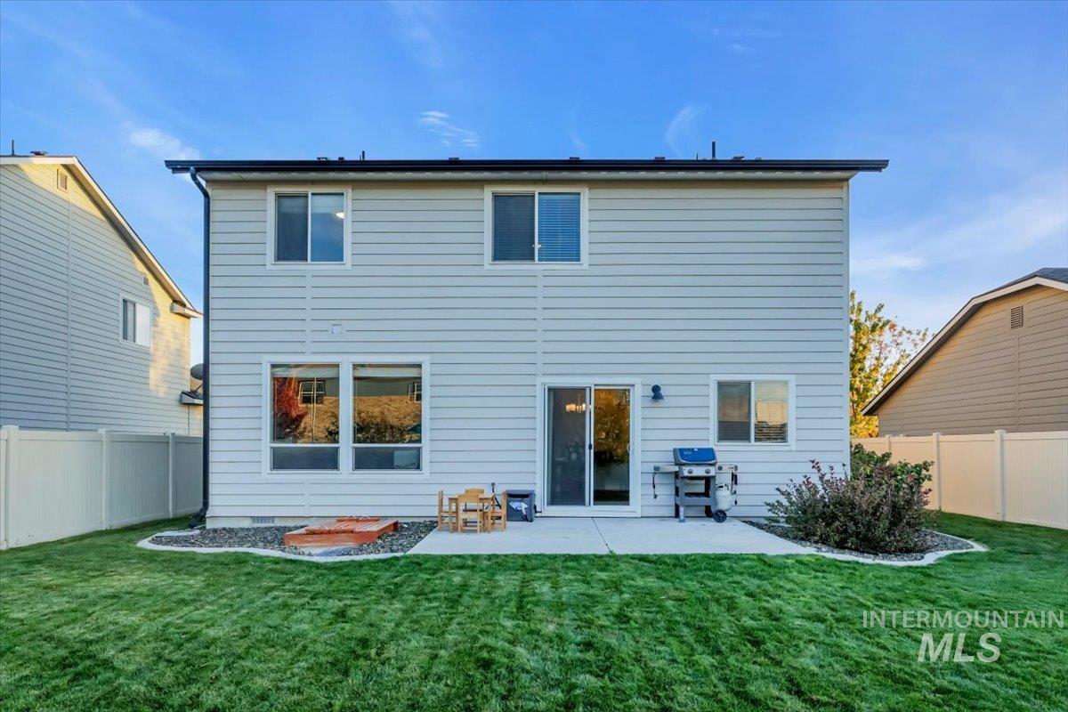 Rear view of property featuring a fenced backyard and a patio area