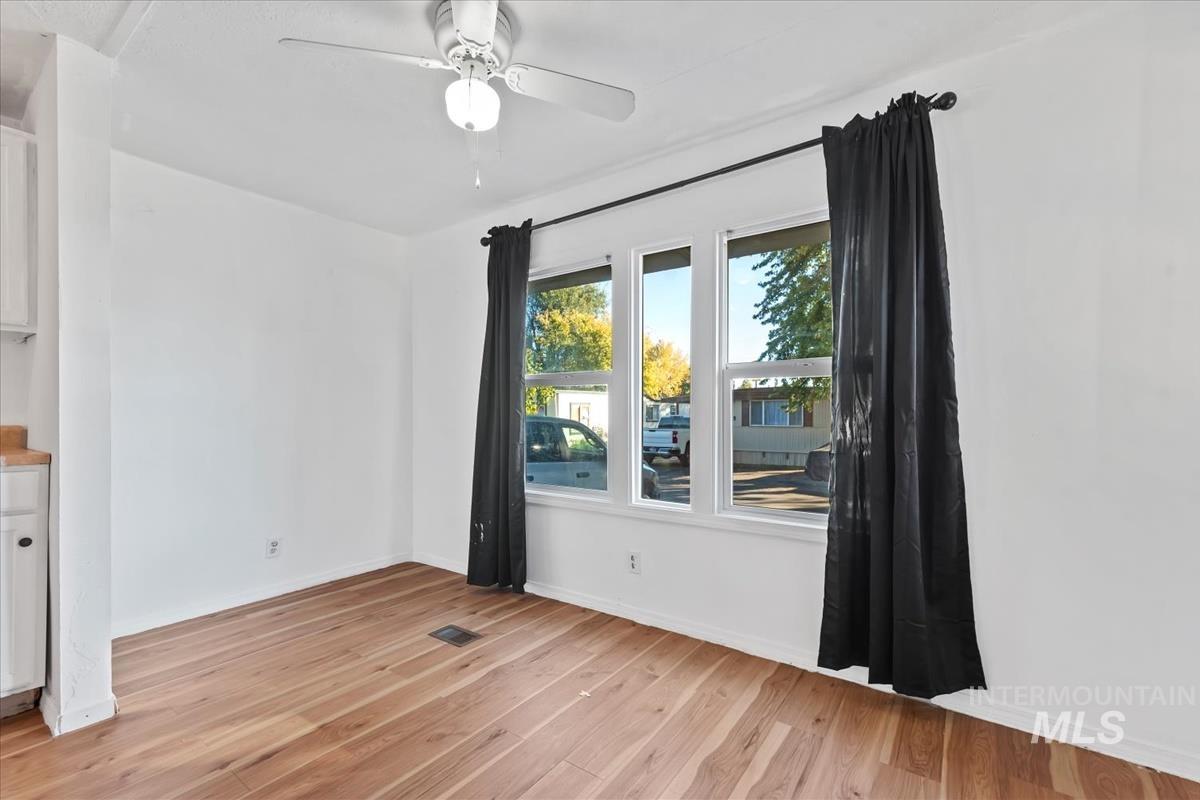 Spare room with light wood-type flooring and a ceiling fan