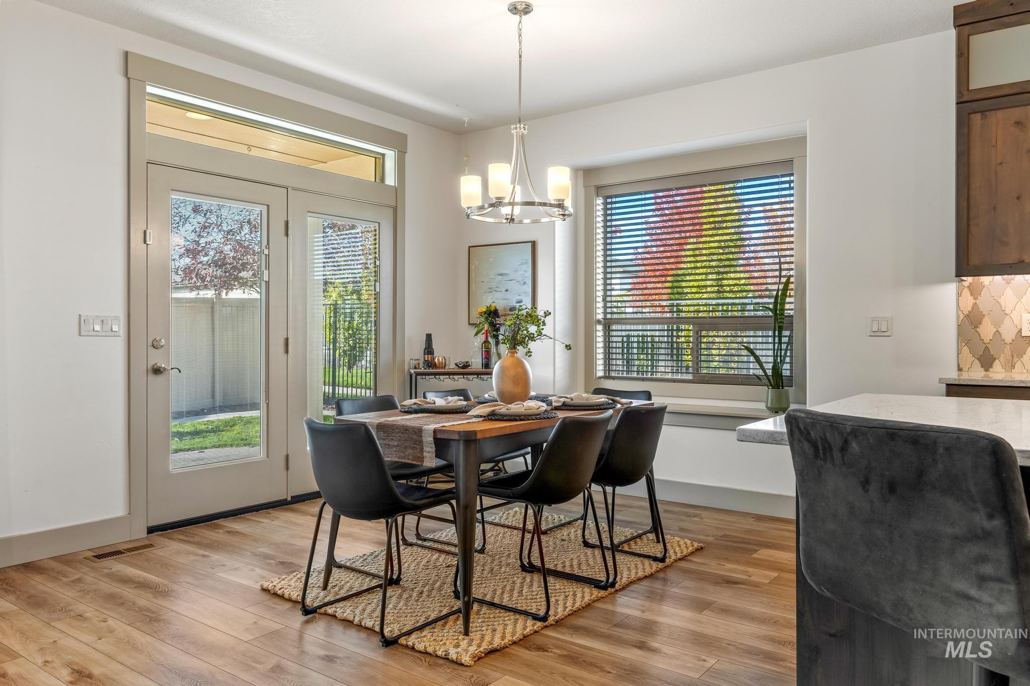 Dining area featuring a chandelier and light wood-style flooring