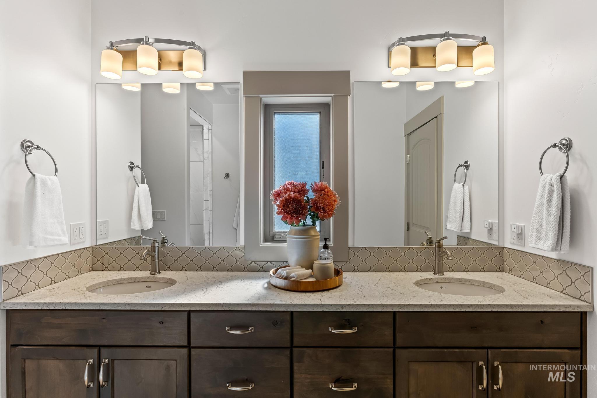 Bathroom with double vanity and decorative backsplash