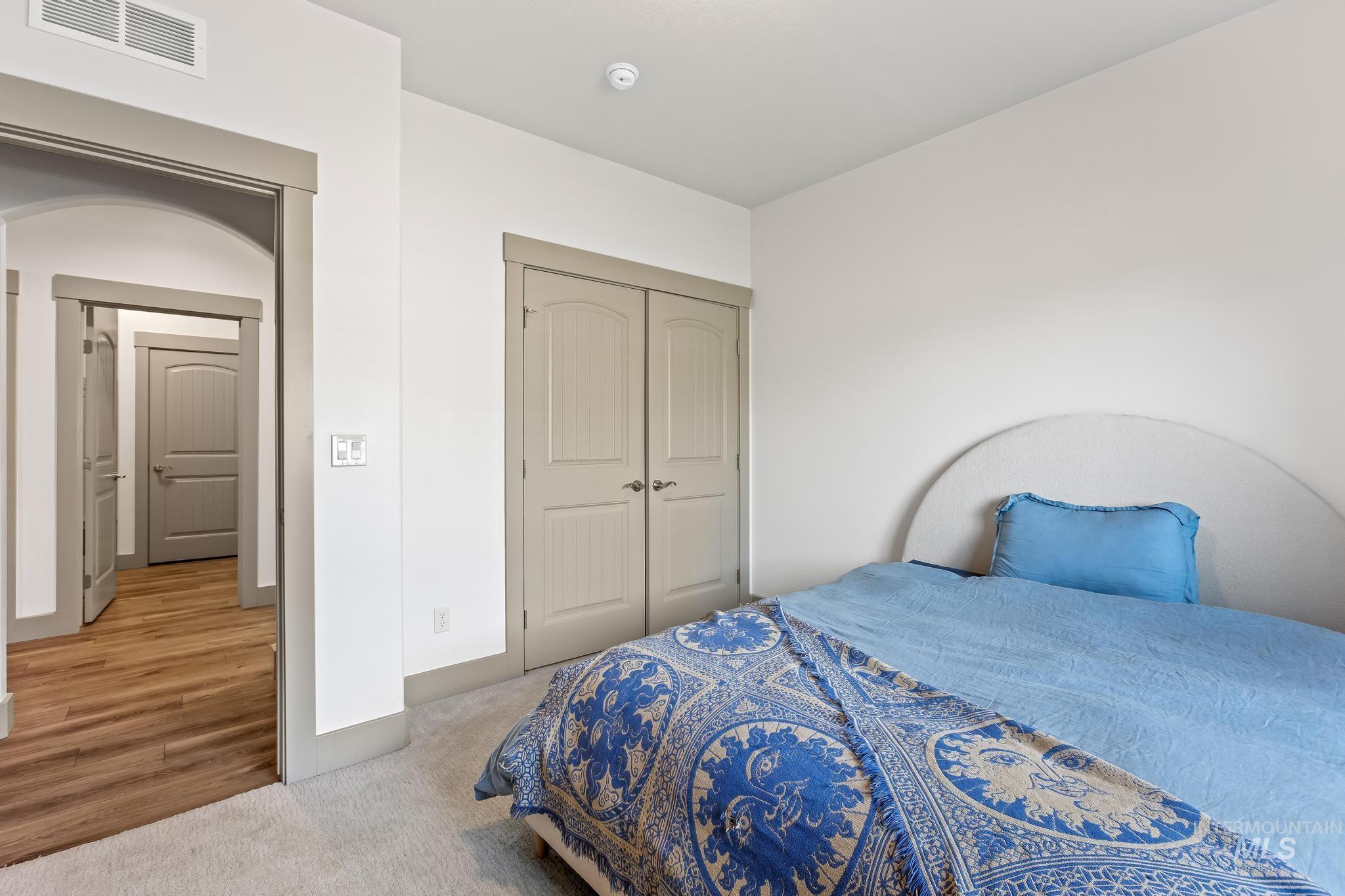 Carpeted bedroom featuring a closet and baseboards