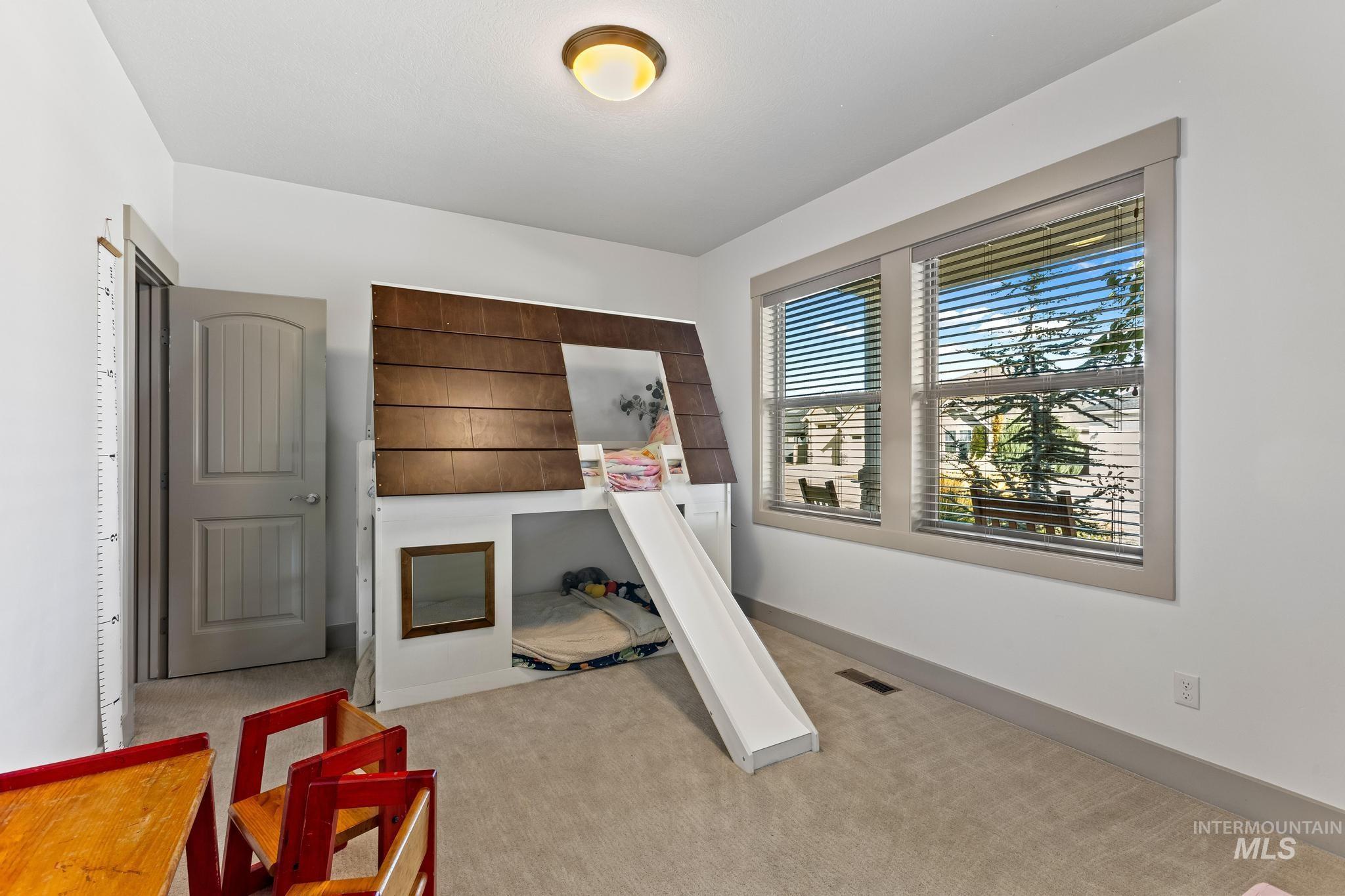 Exercise area with light colored carpet and baseboards