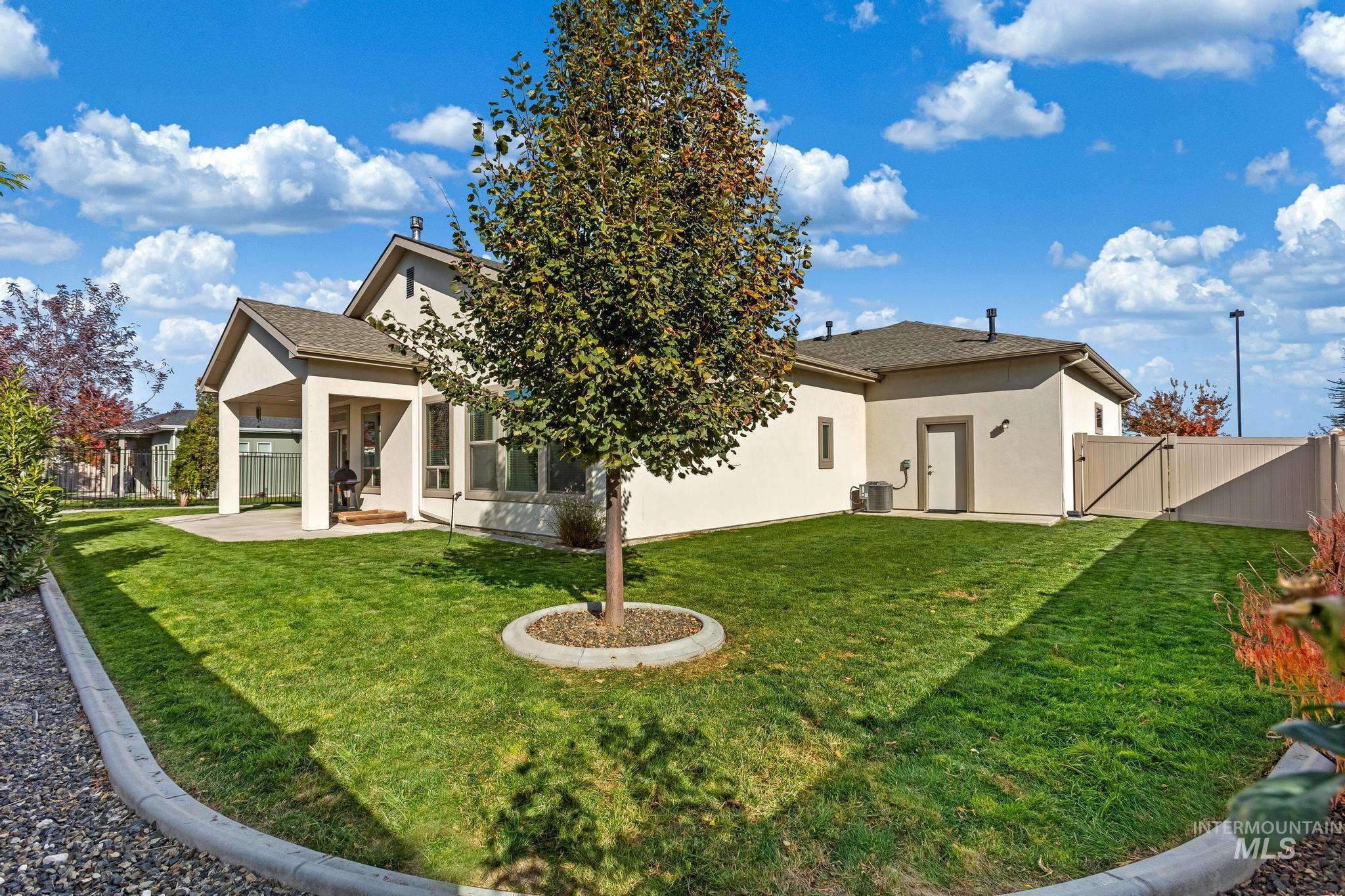 Back of property with a patio area, stucco siding, a gate, and a sunroom