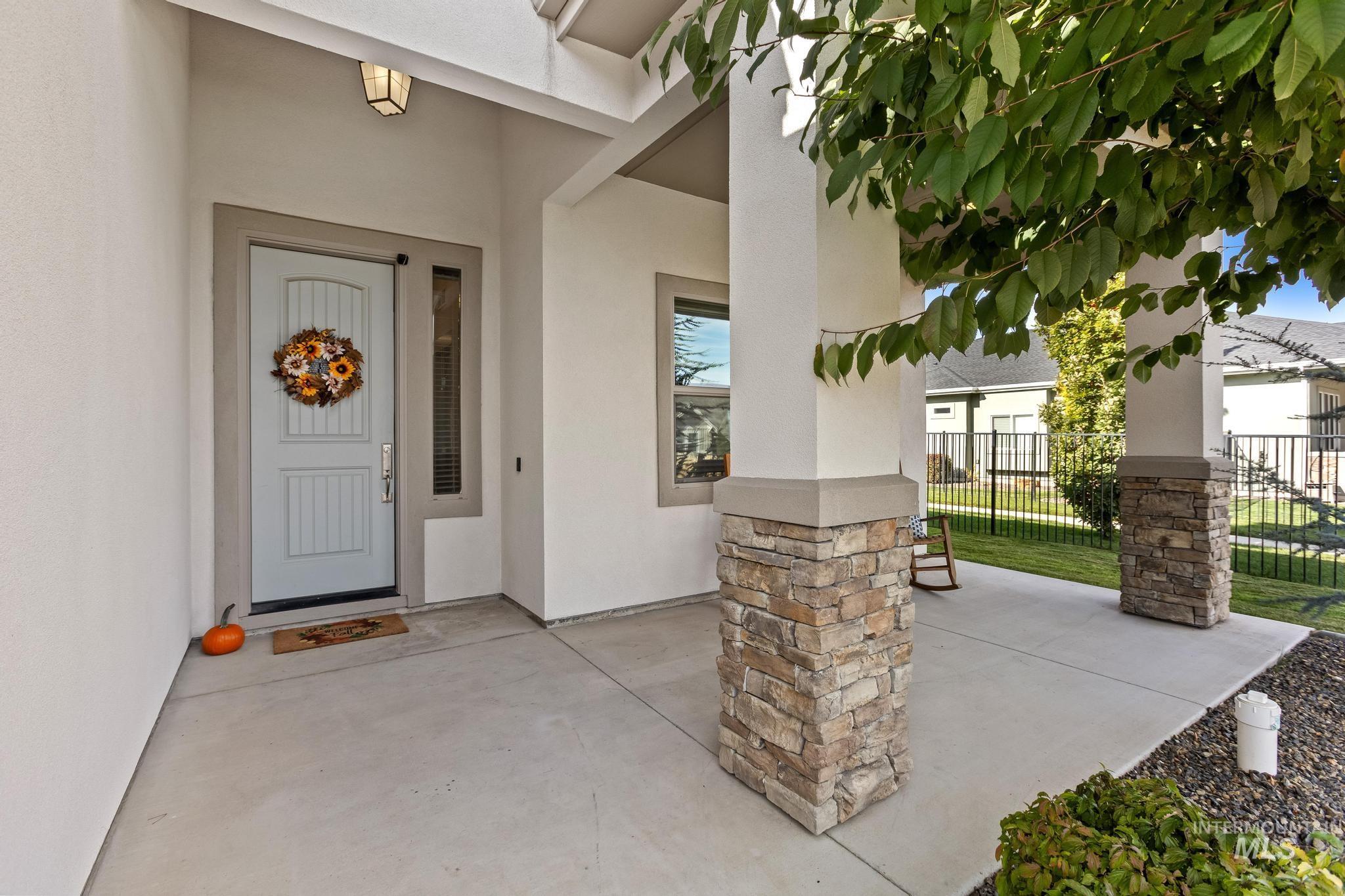 Property entrance featuring stucco siding and a patio