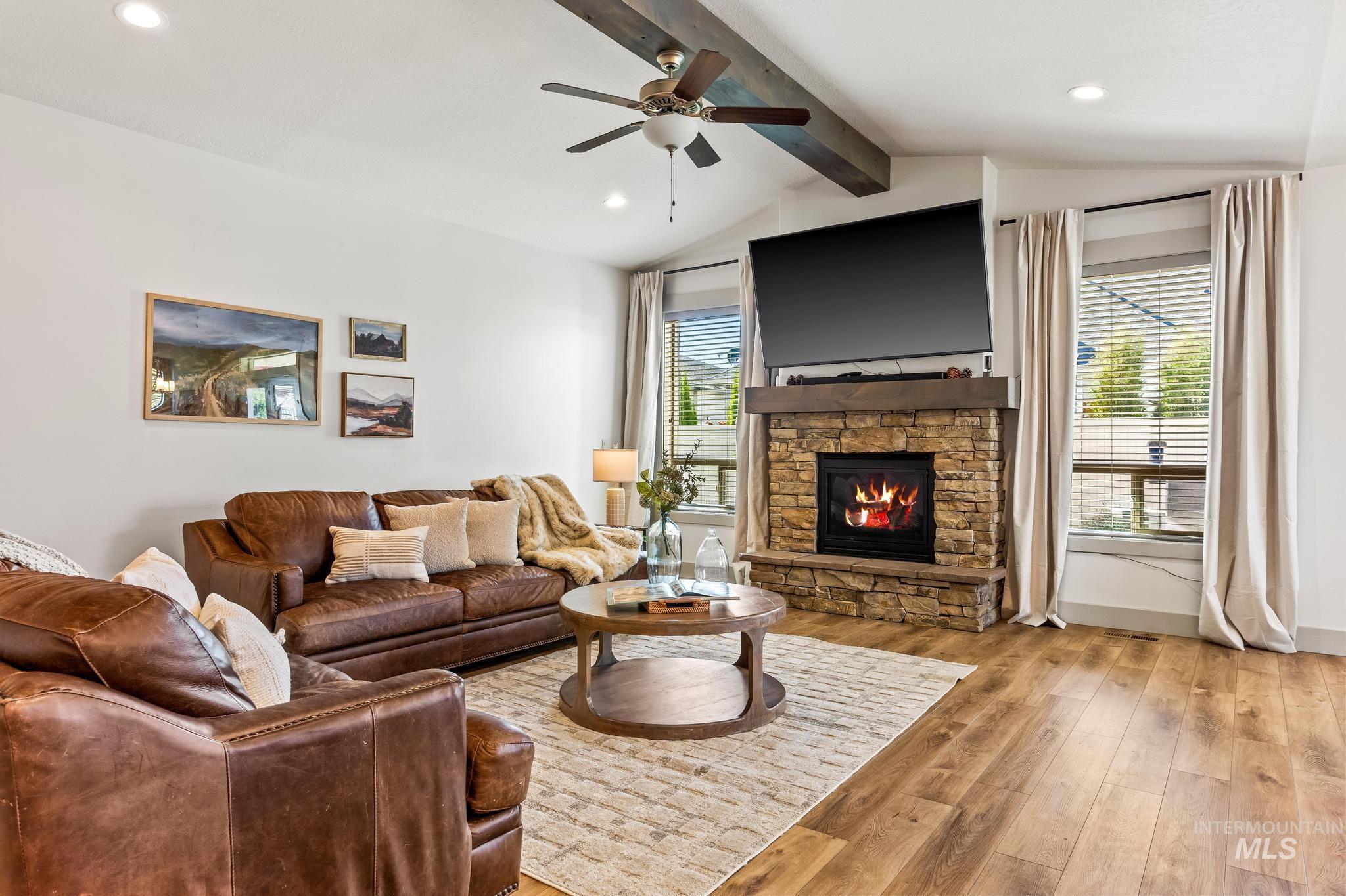 Living room featuring light wood-style flooring, a fireplace, recessed lighting, and ceiling fan