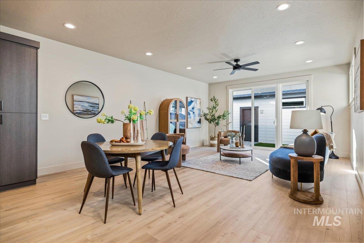 Dining room with recessed lighting, light wood-style flooring, ceiling fan, and a textured ceiling