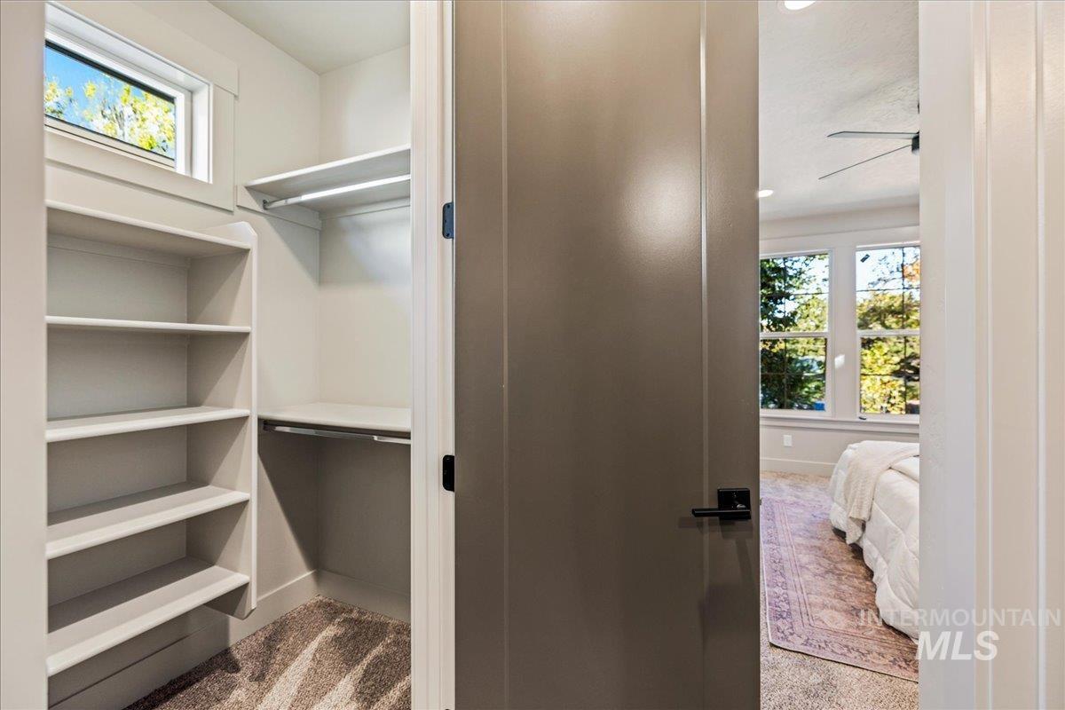 Walk in closet featuring light carpet