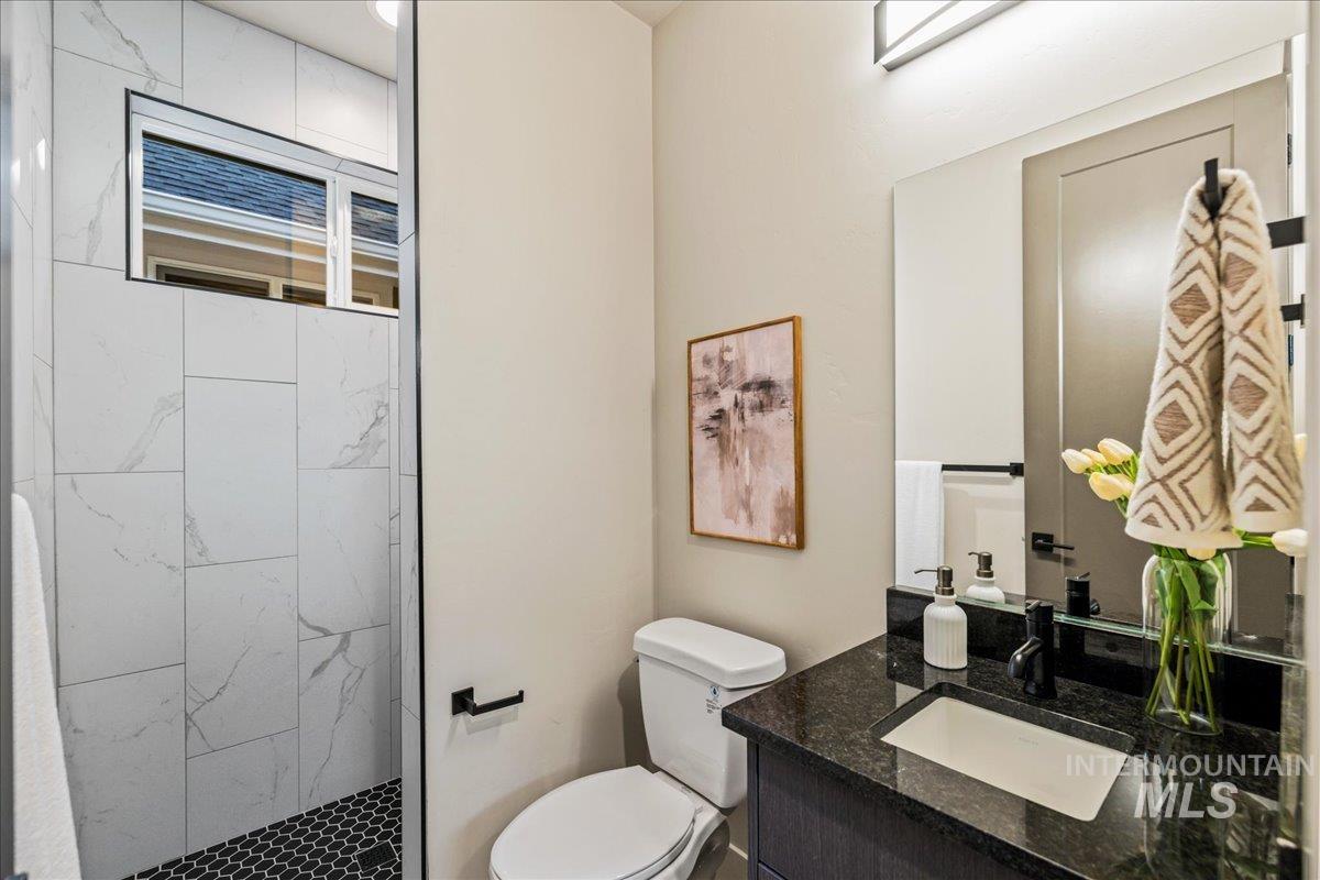Full bath with vanity and a stall shower