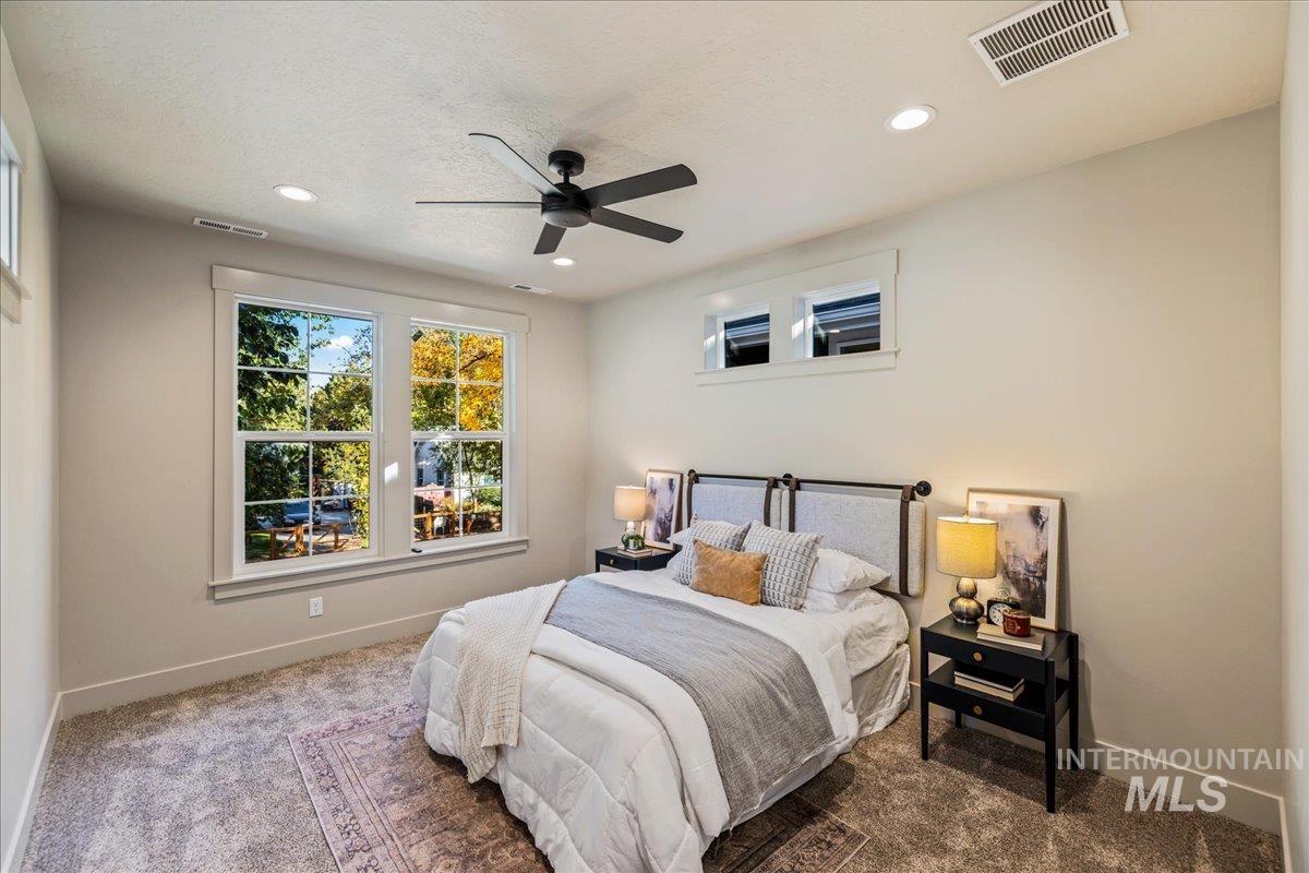 Bedroom featuring carpet floors, ceiling fan, recessed lighting, and a textured ceiling