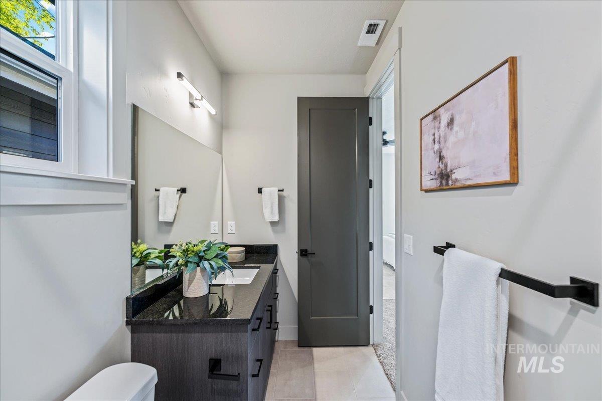 Bathroom featuring vanity and light tile patterned flooring