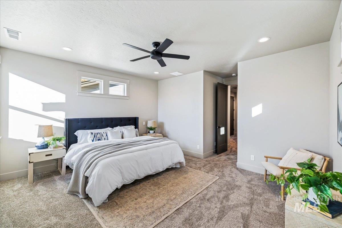 Bedroom featuring carpet flooring, recessed lighting, a ceiling fan, and a textured ceiling