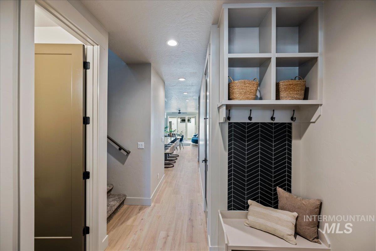 Mudroom featuring light wood-type flooring, recessed lighting, and a textured ceiling