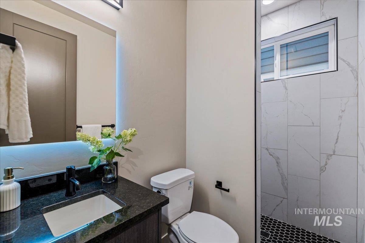 Bathroom with vanity and a tile shower