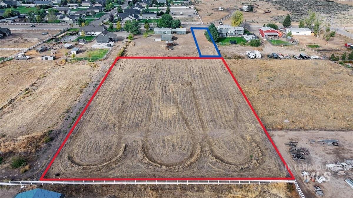 Aerial view of sparsely populated area featuring property parcel outlined