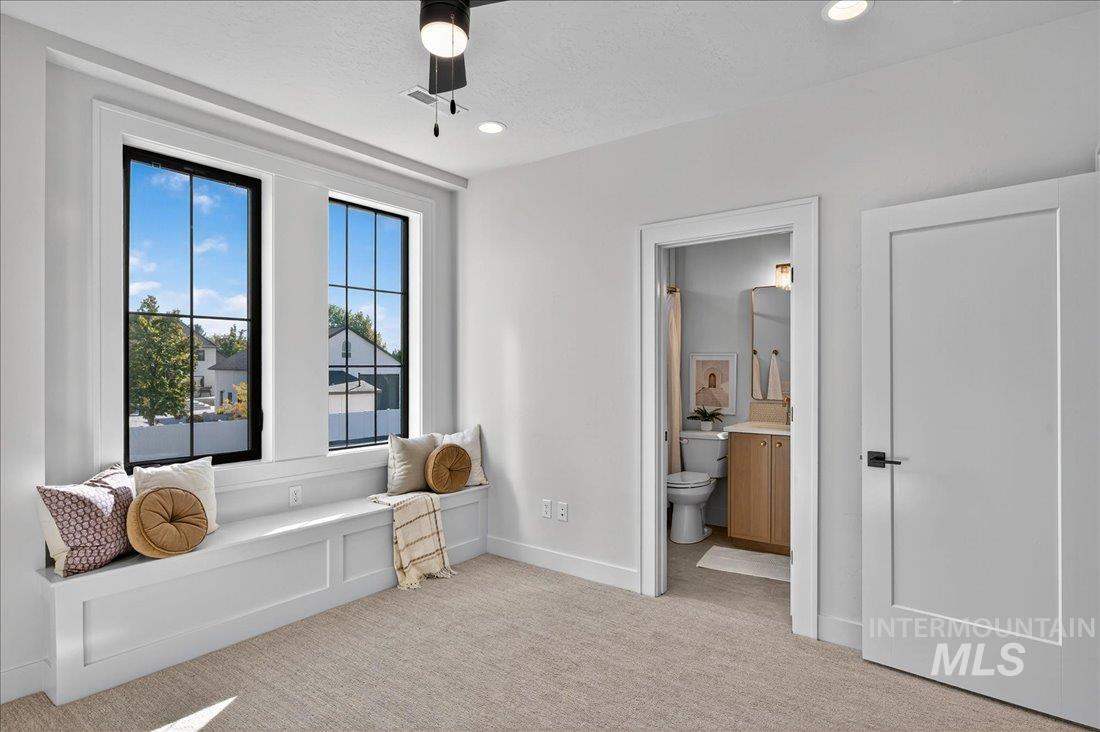 Sitting room with light colored carpet, recessed lighting, and a textured ceiling