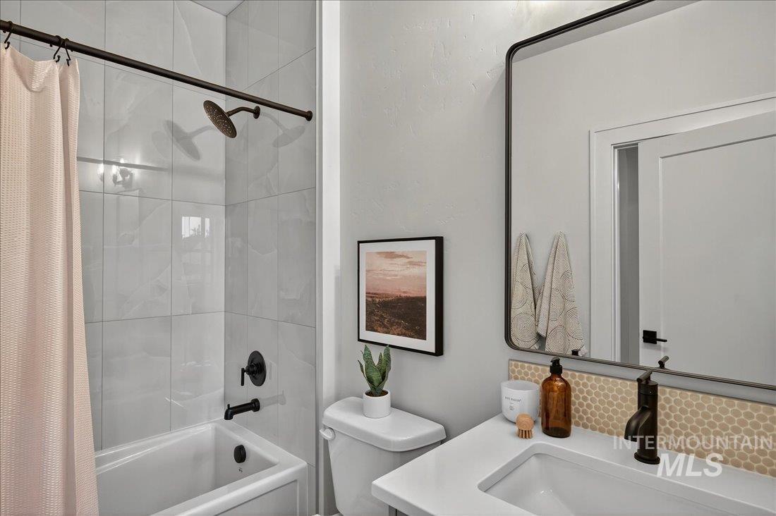 Bathroom featuring shower / bath combo and vanity